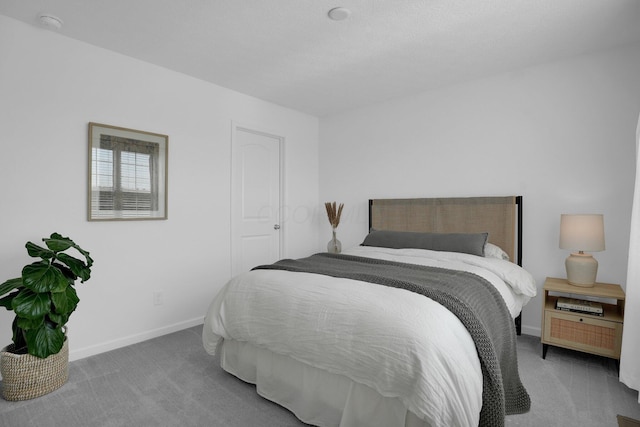 bedroom featuring carpet floors and baseboards