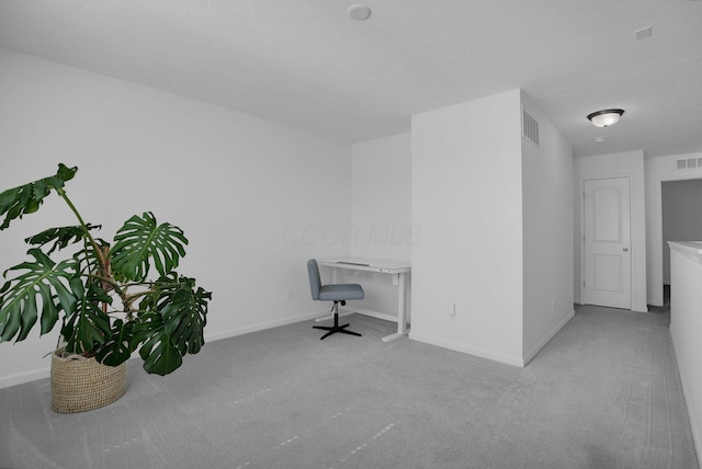interior space featuring baseboards, visible vents, and carpet
