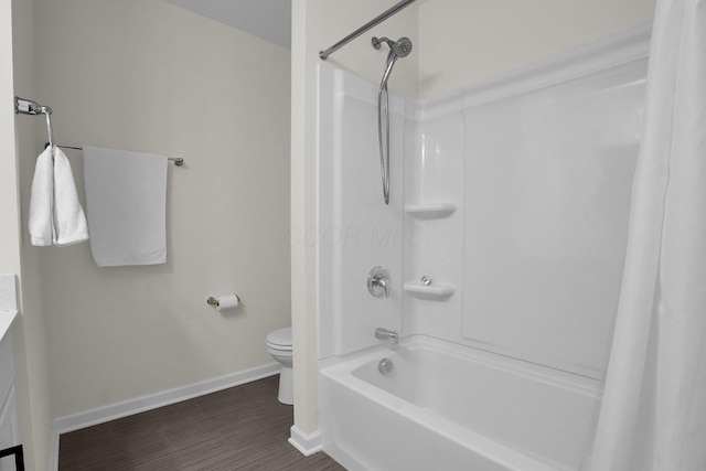 full bath featuring wood finished floors, baseboards, vanity, toilet, and shower / bathtub combination with curtain