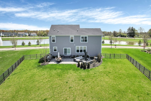back of house featuring a yard, a water view, a fenced backyard, and a patio area