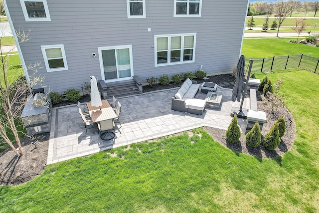 back of property featuring fence, a patio, an outdoor living space, entry steps, and a lawn