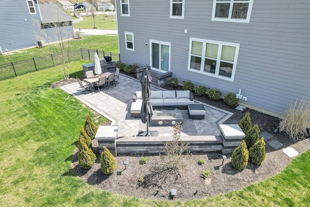 rear view of house featuring a lawn, fence, an outdoor living space, and a patio area