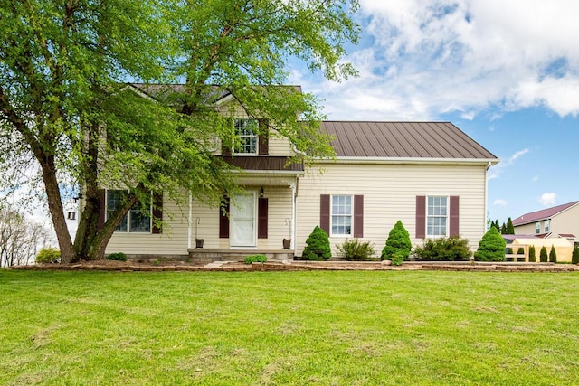 cape cod house with metal roof and a front yard