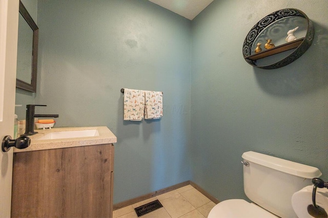 bathroom with toilet, vanity, visible vents, tile patterned floors, and baseboards