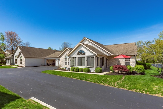 single story home with a front yard and stone siding