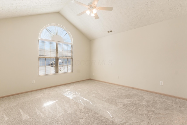 carpeted spare room with a ceiling fan, baseboards, visible vents, and vaulted ceiling