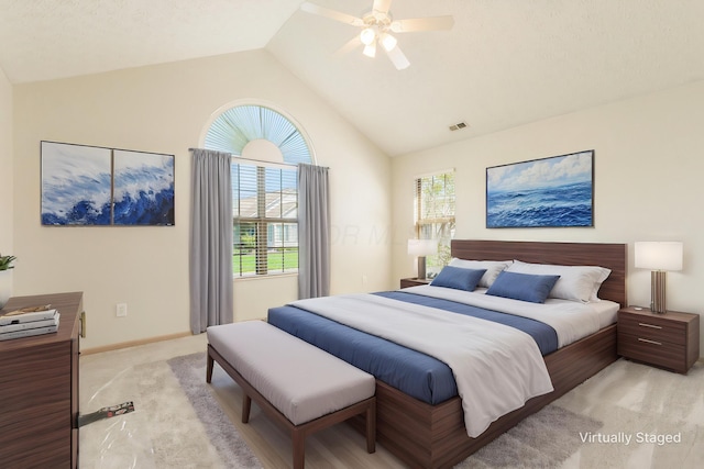 bedroom featuring a ceiling fan, visible vents, vaulted ceiling, baseboards, and light carpet