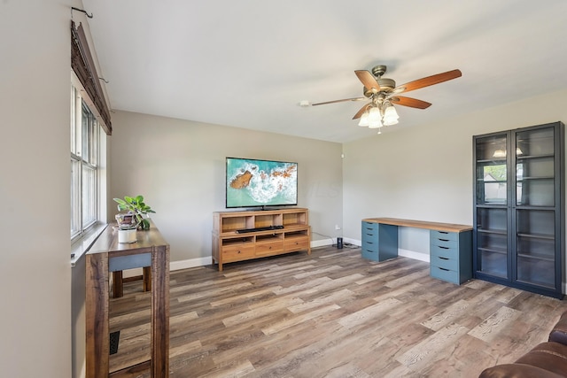 home office with ceiling fan, plenty of natural light, and light wood-style floors