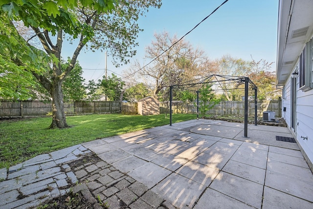 view of patio / terrace featuring cooling unit, a fenced backyard, a shed, a gazebo, and an outbuilding