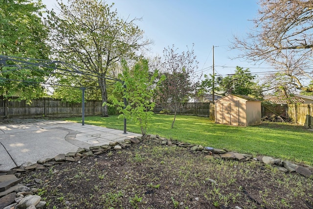 view of yard with an outbuilding, a fenced backyard, a patio area, and a shed