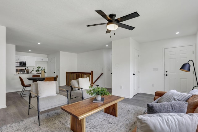 living room featuring wood finished floors, recessed lighting, a ceiling fan, and baseboards