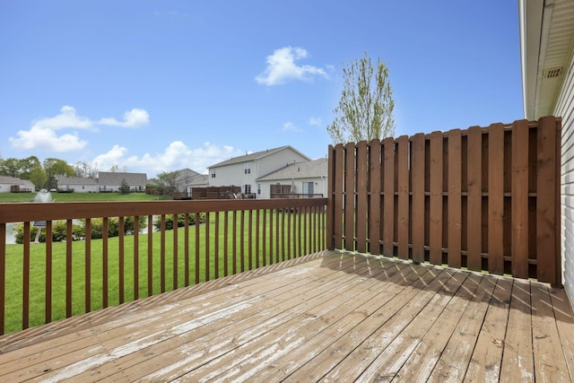 wooden deck with a residential view and a yard