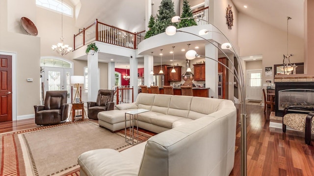 87 Dartmouth Rd SE, Hebron, OH 43025 - living area with a chandelier, high vaulted ceiling, a multi sided fireplace, baseboards, and wood finished floors