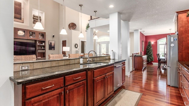 87 Dartmouth Rd SE, Hebron, OH 43025 - kitchen featuring a sink, stainless steel appliances, baseboards, wood finished floors, and hanging light fixtures