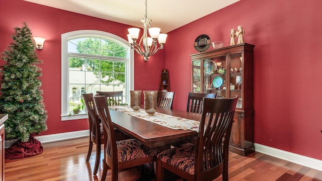 87 Dartmouth Rd SE, Hebron, OH 43025 - dining space with a notable chandelier, wood finished floors, and baseboards