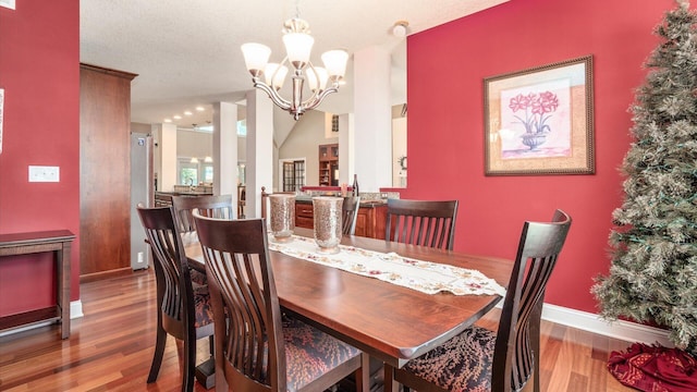 87 Dartmouth Rd SE, Hebron, OH 43025 - dining area with baseboards, wood finished floors, and a notable chandelier