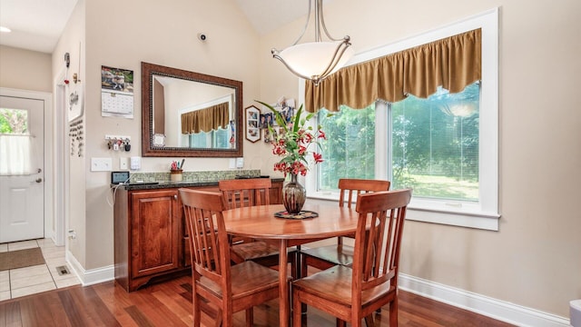 87 Dartmouth Rd SE, Hebron, OH 43025 - dining room featuring dark wood finished floors, lofted ceiling, and baseboards