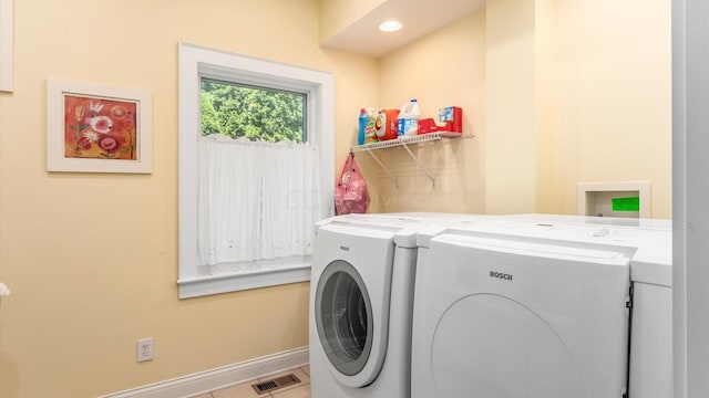 87 Dartmouth Rd SE, Hebron, OH 43025 - laundry area with tile patterned flooring, laundry area, washing machine and clothes dryer, baseboards, and visible vents