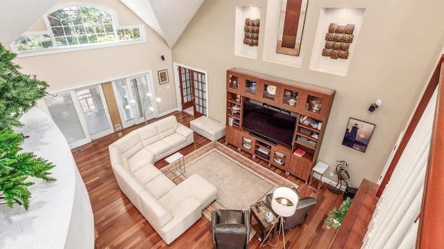 87 Dartmouth Rd SE, Hebron, OH 43025 - living room with high vaulted ceiling, wood finished floors, and baseboards