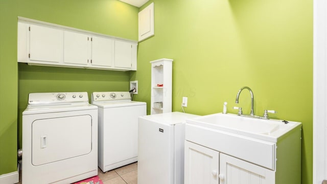 87 Dartmouth Rd SE, Hebron, OH 43025 - clothes washing area with light tile patterned floors, cabinet space, and washing machine and dryer