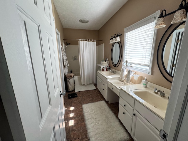 bathroom with tile patterned floors, two vanities, shower / tub combo with curtain, and a sink
