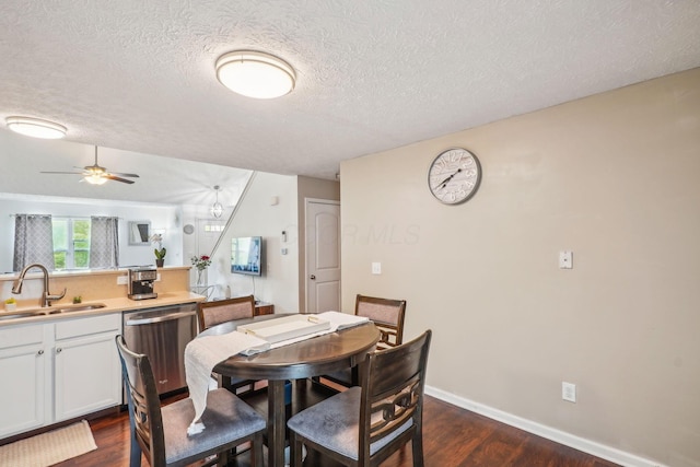 dining area with a textured ceiling, a ceiling fan, baseboards, and dark wood finished floors