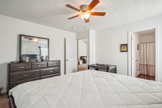 bedroom with a textured ceiling, ceiling fan, and ensuite bath