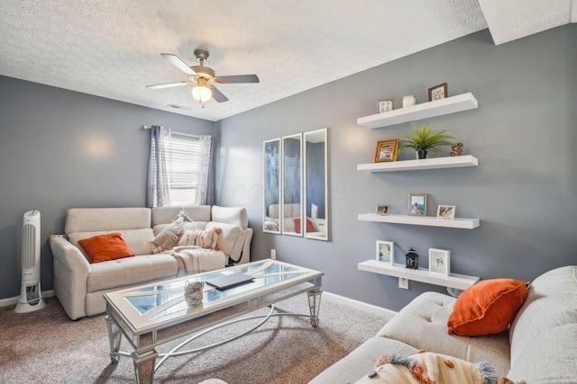 living area featuring a textured ceiling, ceiling fan, carpet, and baseboards