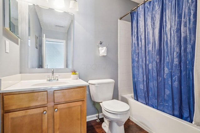 full bathroom featuring visible vents, toilet, shower / bath combination with curtain, wood finished floors, and vanity