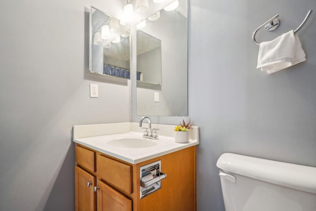 bathroom featuring toilet and vanity