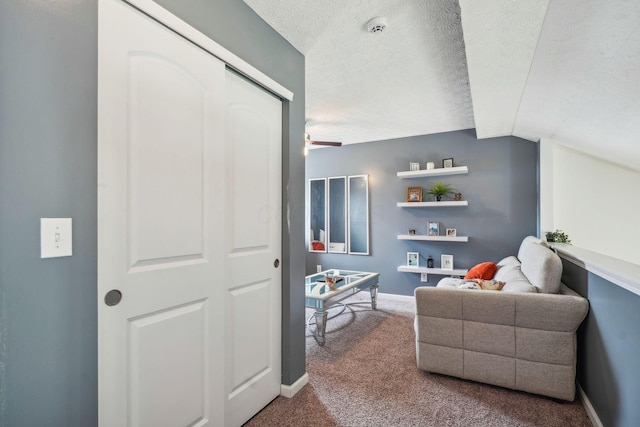 interior space featuring baseboards, a textured ceiling, and vaulted ceiling