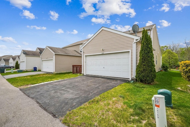view of front of home with a garage and a front lawn