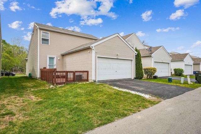 view of property featuring a front yard, driveway, and an attached garage