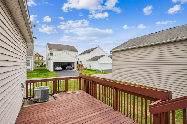 deck with a yard, central air condition unit, and a residential view
