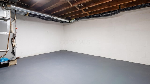 basement with concrete block wall and heating unit