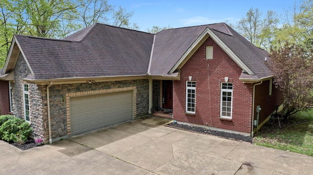 4611 Meghans Run, Batavia, OH 45103 - ranch-style home featuring concrete driveway, a shingled roof, stone siding, and a garage