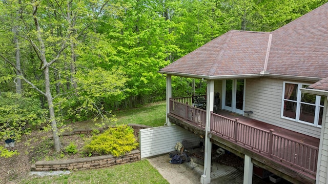 4611 Meghans Run, Batavia, OH 45103 - exterior space with a yard, a deck, a view of trees, and a shingled roof