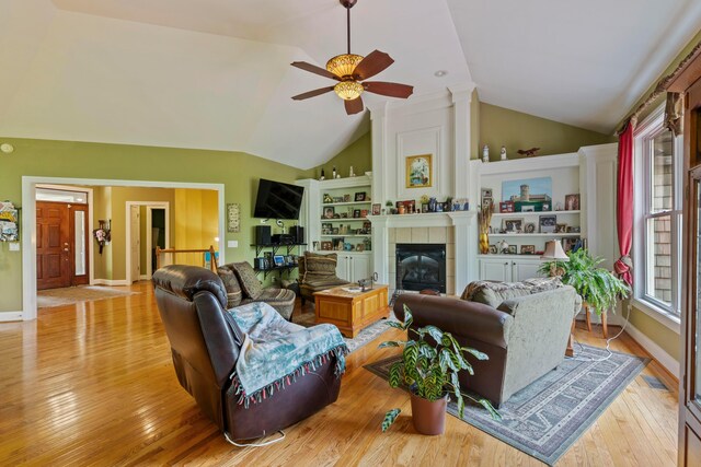 4611 Meghans Run, Batavia, OH 45103 - living room featuring a ceiling fan, vaulted ceiling, wood finished floors, and a tile fireplace
