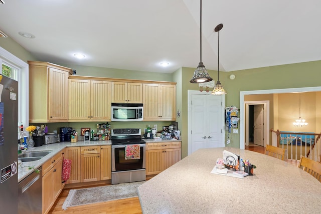 4611 Meghans Run, Batavia, OH 45103 - kitchen featuring hanging light fixtures, appliances with stainless steel finishes, a sink, light wood-style floors, and a chandelier