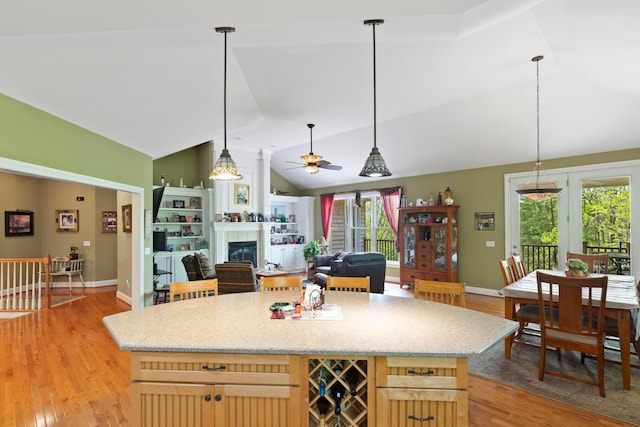 4611 Meghans Run, Batavia, OH 45103 - kitchen featuring a tiled fireplace, a ceiling fan, light wood finished floors, and lofted ceiling