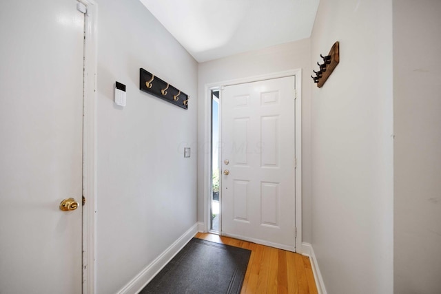 doorway to outside with light wood-style floors and baseboards