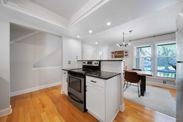 kitchen featuring light wood-style flooring, a chandelier, stainless steel electric stove, recessed lighting, and white cabinetry
