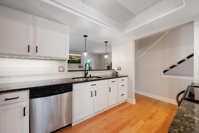 kitchen with light wood-type flooring, white cabinetry, tasteful backsplash, a sink, and dishwasher
