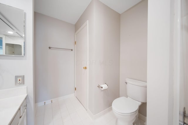 bathroom with toilet, baseboards, and vanity