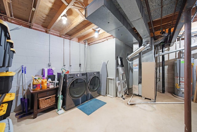 unfinished below grade area featuring heating unit, gas water heater, and washer and clothes dryer