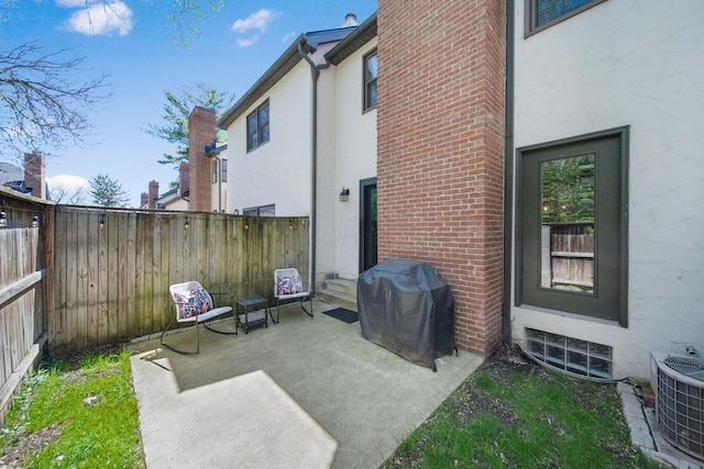 exterior space with central air condition unit, fence, and a grill