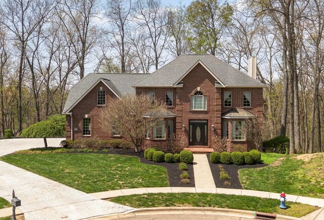 1917 Nichole Cir, Lancaster, OH 43130 - colonial home with a chimney, brick siding, a front lawn, and concrete driveway
