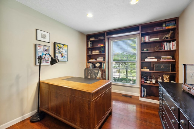 6767 Burnside Ln, Dublin, OH 43016 - office area featuring baseboards, visible vents, a textured ceiling, and dark wood-style floors