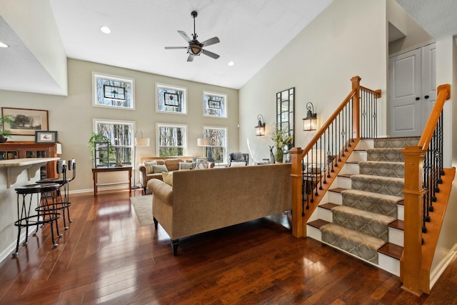 6767 Burnside Ln, Dublin, OH 43016 - living room featuring ceiling fan, dark wood-style floors, recessed lighting, high vaulted ceiling, and stairs