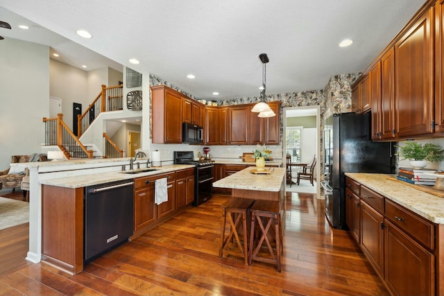 6767 Burnside Ln, Dublin, OH 43016 - kitchen featuring double oven range, black microwave, dishwashing machine, and dark wood-type flooring